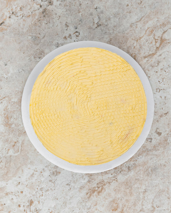 Aerial image of a Plain San Rival round cake, frosted with original buttercream. 